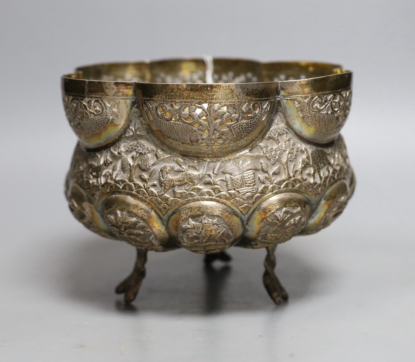 An Indian embossed white metal bowl, on three entwined serpent feet, diameter 17.5cm, 13.9oz.